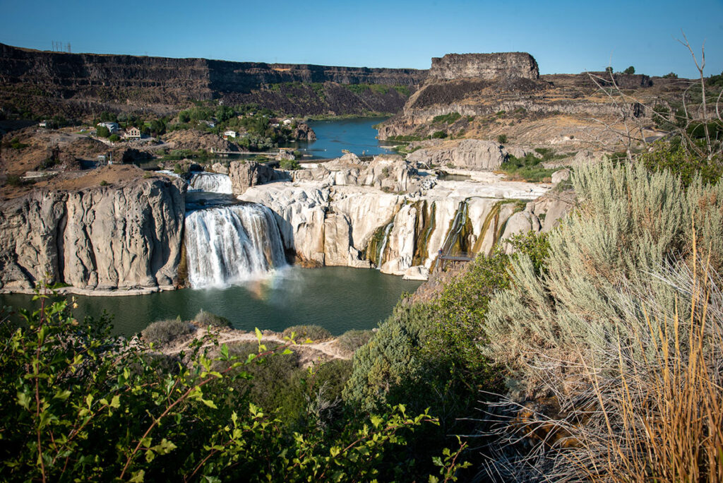 Water cascades down a large rock face